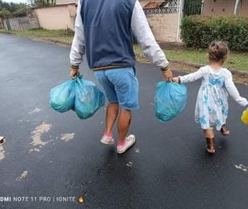 Families carrying home their food parcels